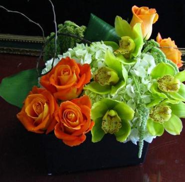 Beautiful orange roses, green cymbidium orchids, couture centerpieces